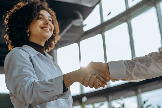 woman shaking hands with person